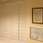 White shutter blinds - subtle window coverings on bedroom wall